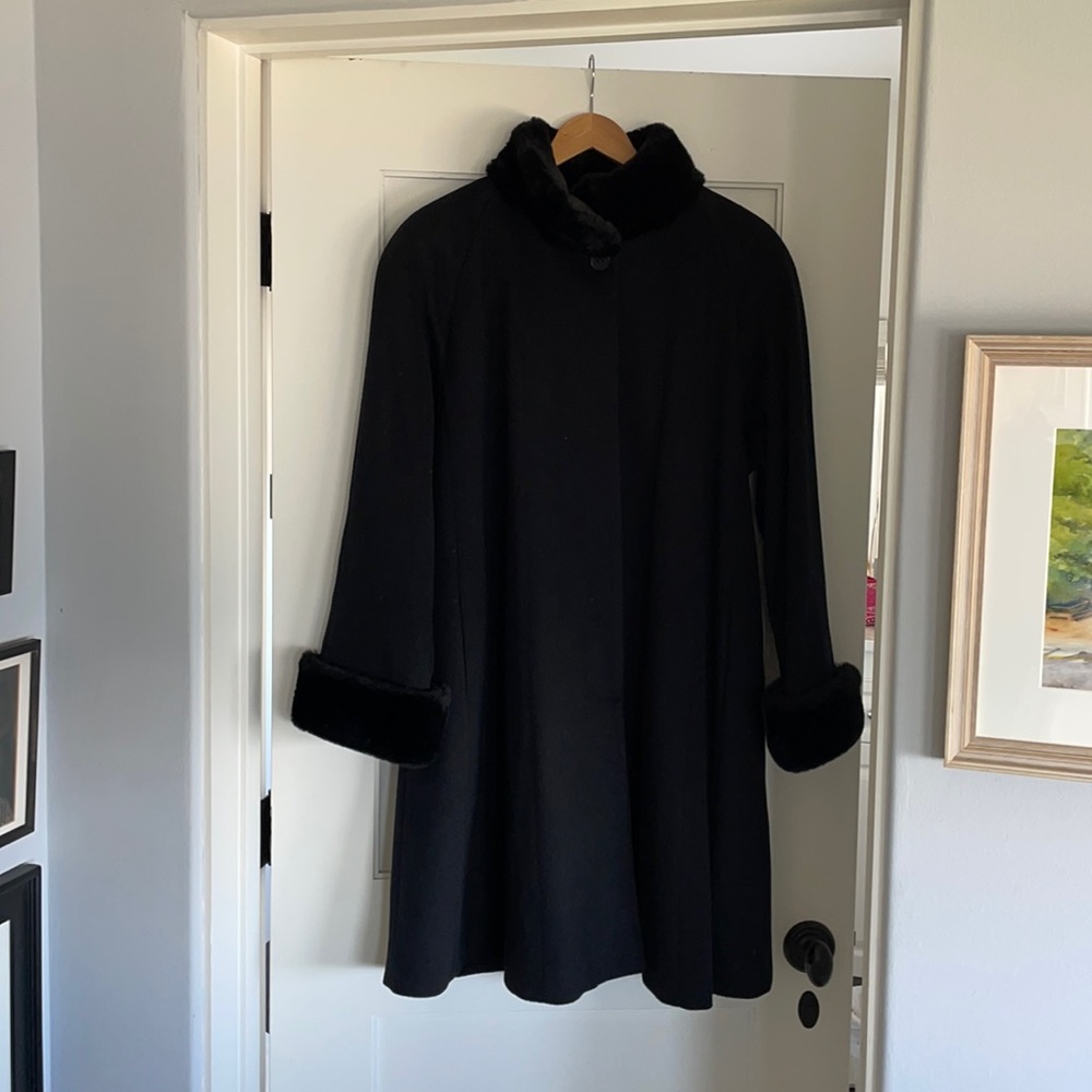 Knee length cape style overcoat with faux fur neck and sleeve trim. Cape style